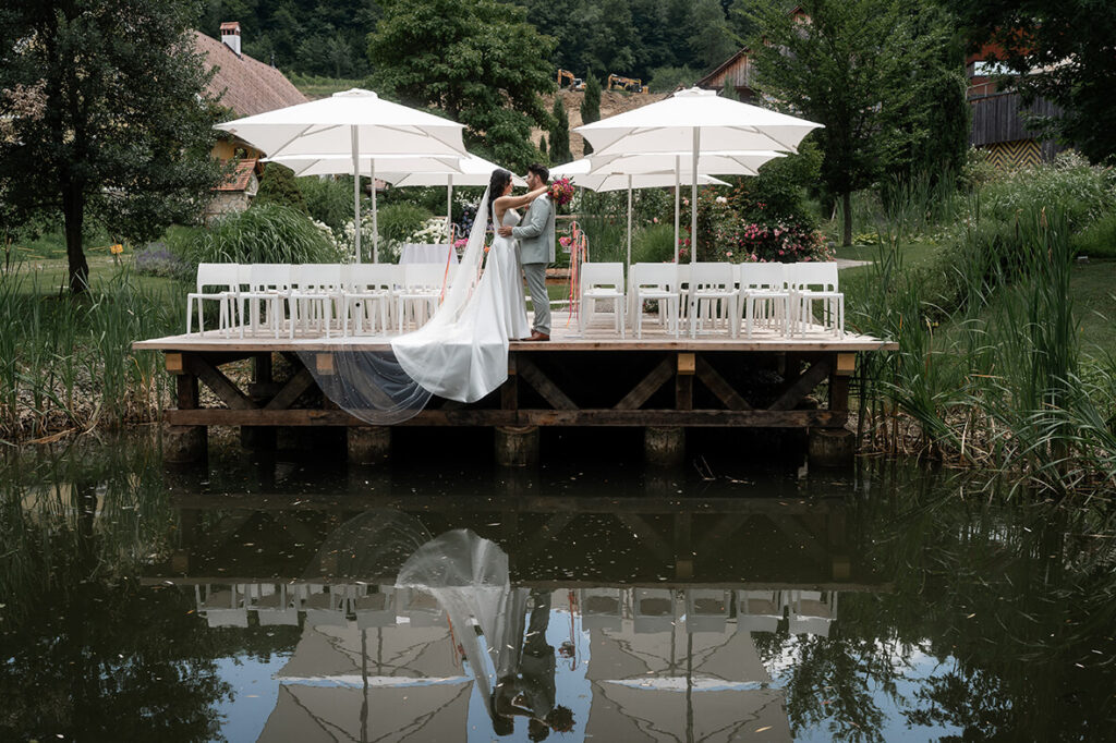 Hochzeit Julia und Stefan - Brautpaar steht auf einem Steg und umarmt sich